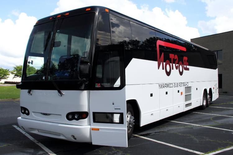 a Boston Charter Bus Company branded charter bus parks with the door open